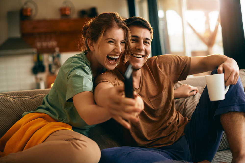 Family watching TV together in a living room